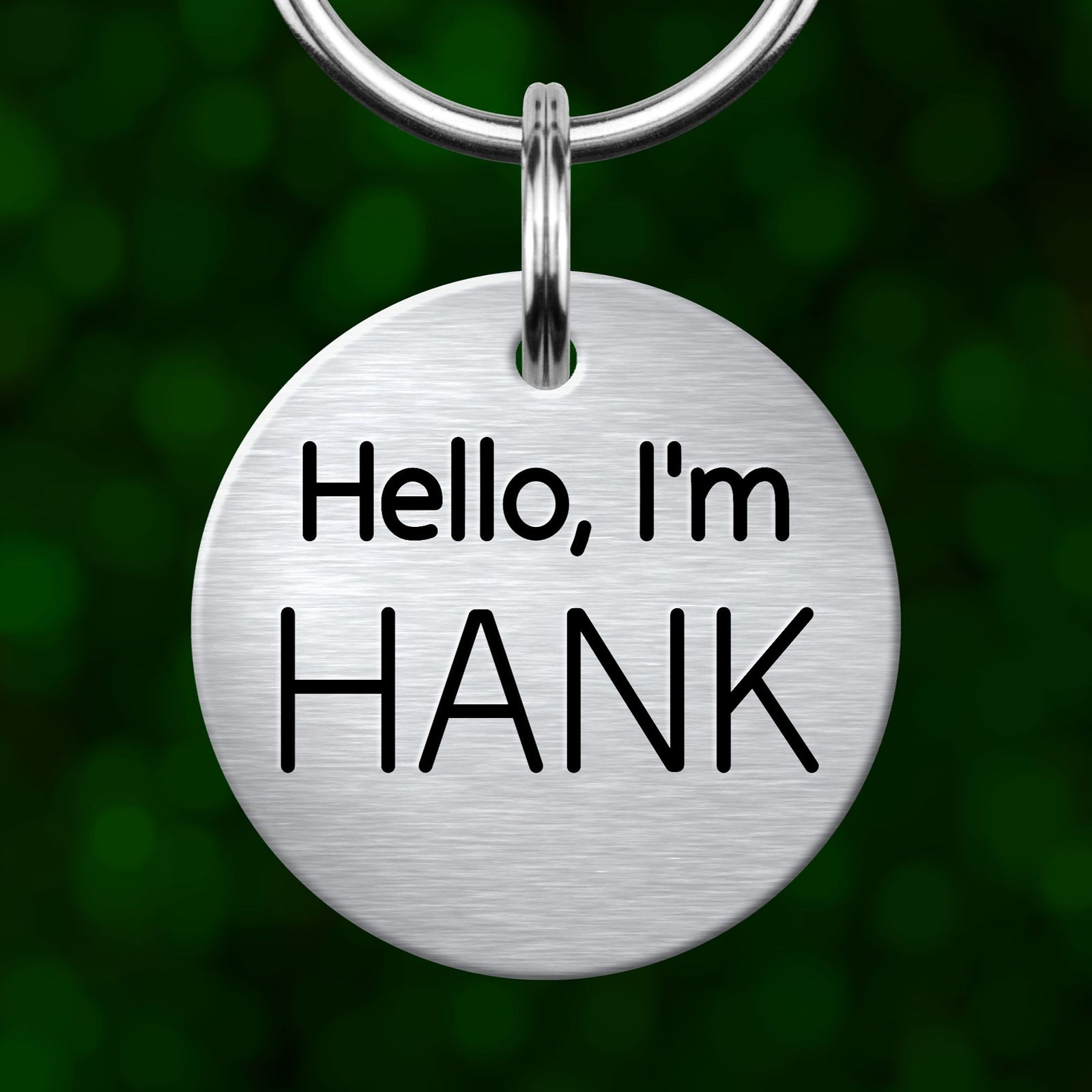 A silver-colored keychain tag with the text "Hello, I'm HANK" printed on it.