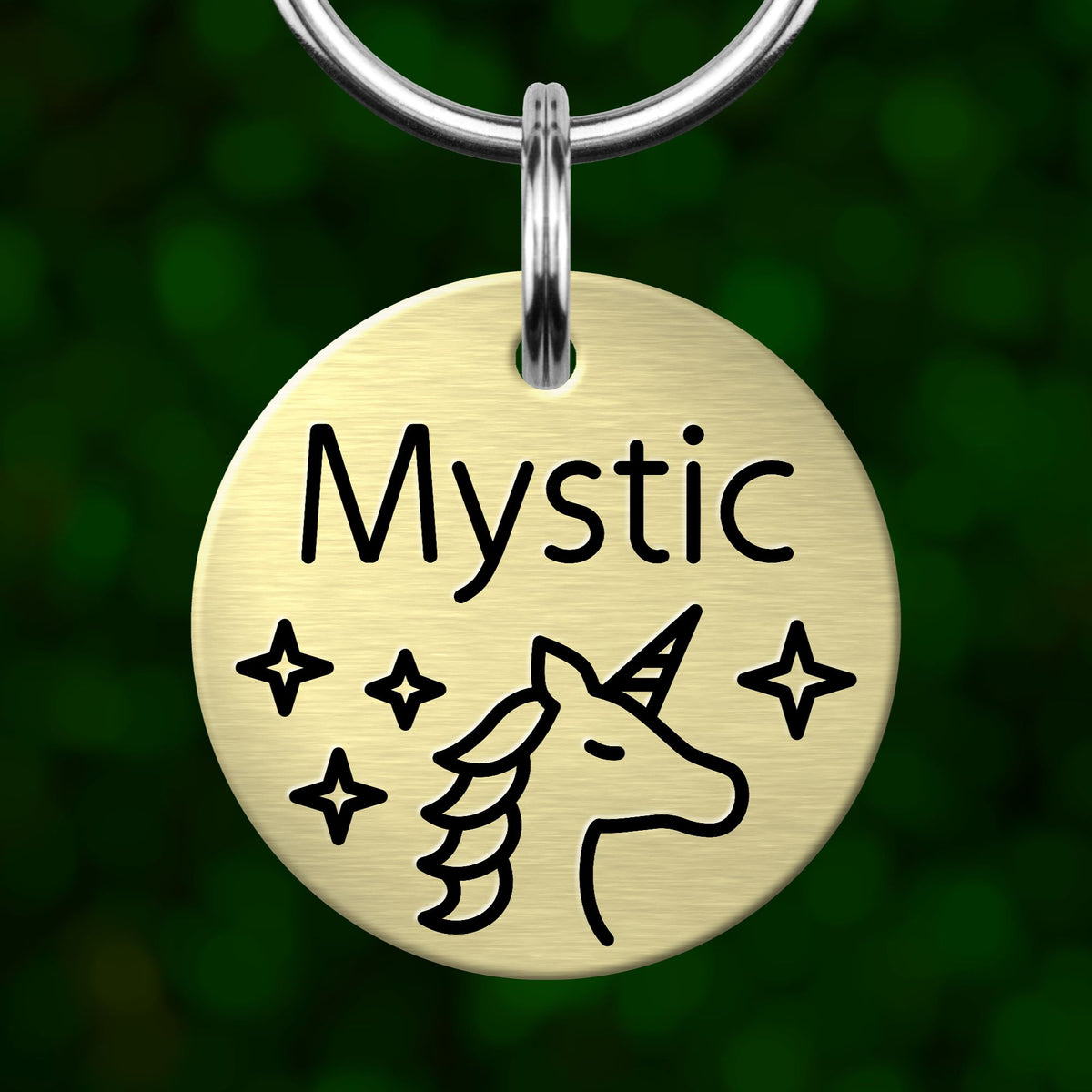 A round metal pet tag with the word "Mystic" and a unicorn illustration on it.