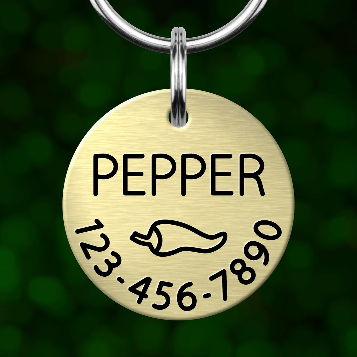 A round metal pet tag with the name "Pepper" printed on it, along with a phone number.