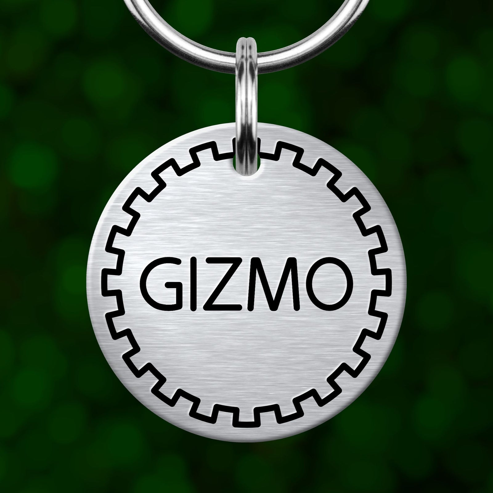 A silver metal keychain tag with the word "GIZMO" printed on it.