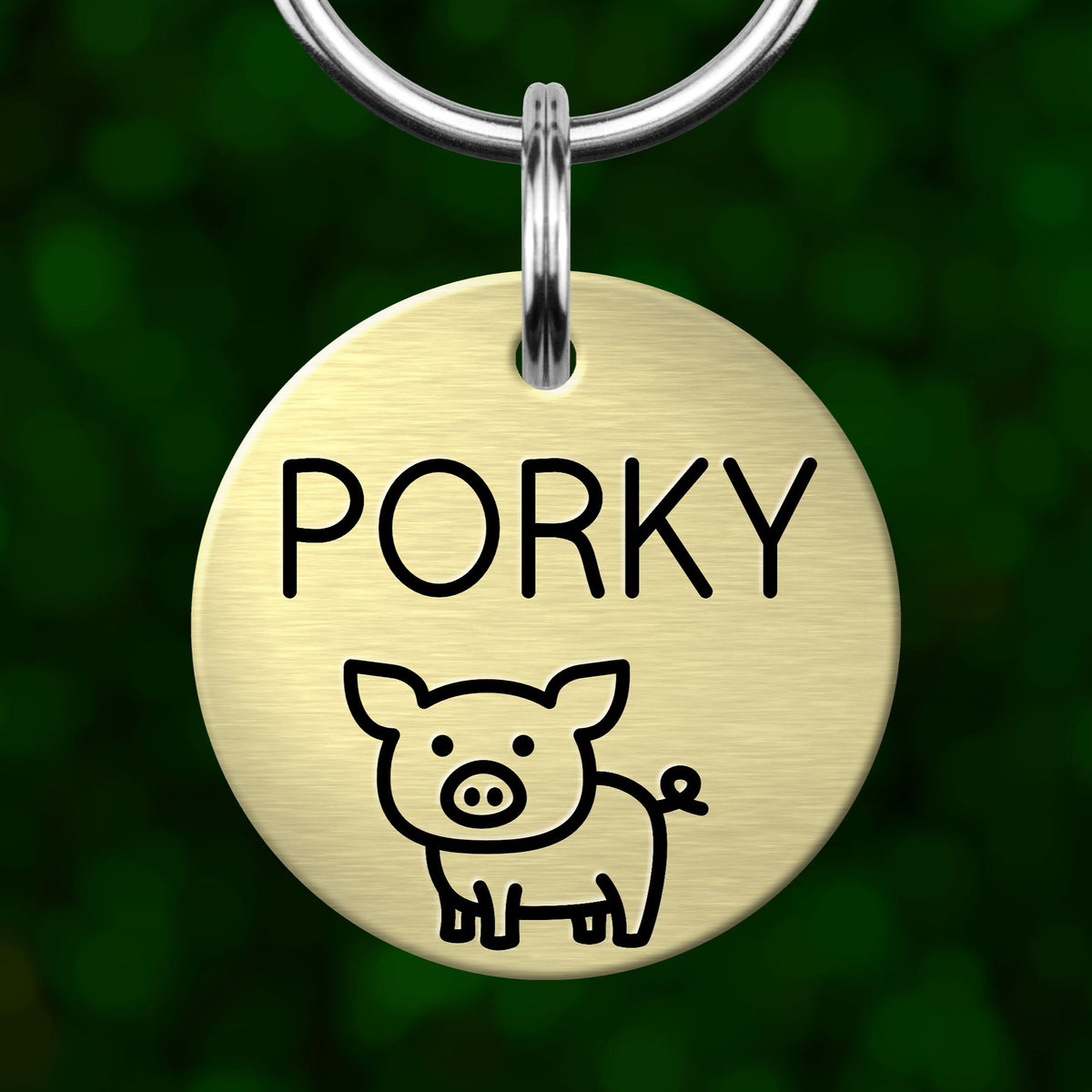 A round metal pet tag with the name "Porky" and a simple illustration of a pig.