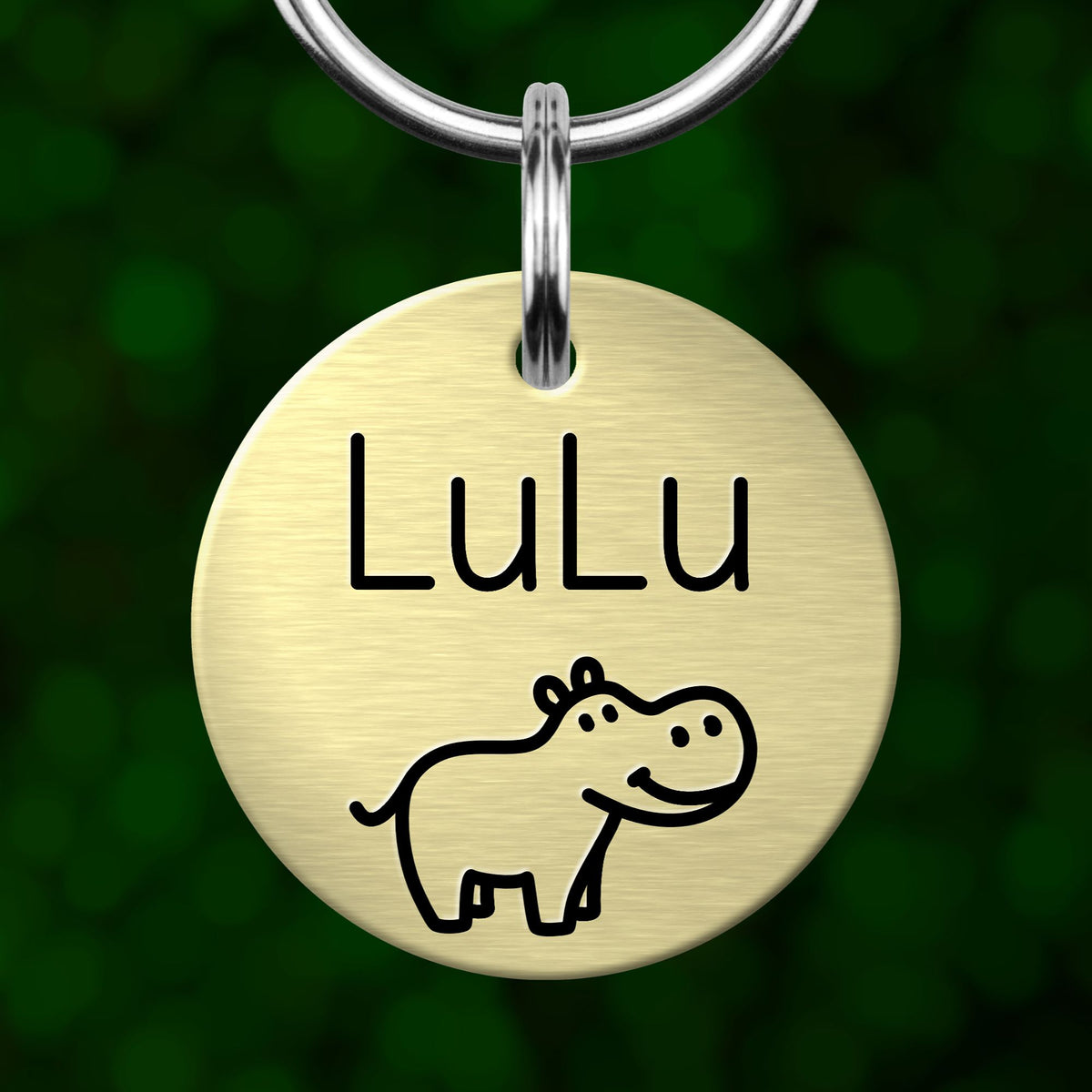 A round metal keychain tag with the name "Lulu" and a cartoon hippo illustration.